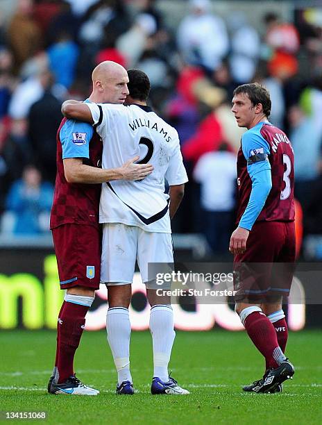 Ashley Williams of Swansea shakes hands with fellow Wales international player James Collins of Aston Villa after the Barclays Premier League match...