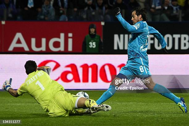 Danko Lazovic of FC Zenit St Petersburg tries to shoot past goalkeeper Guilherme of FC Lokomotiv Moscow during the Russian Premier League match...