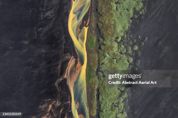 braided river flowing across a black sand beach photographed by drone, iceland - volcanic landscape stock pictures, royalty-free photos & images