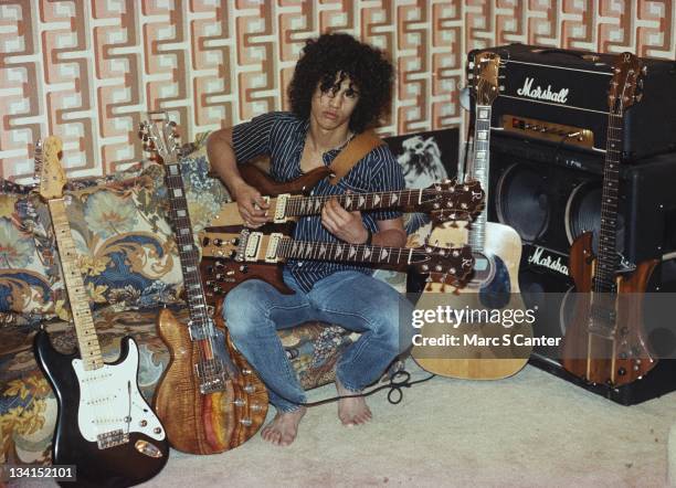 Guitarist Slash poses for a portrait in his bedroom with his guitars and a Marshall halfstack amplifier in 1983 in Los Angeles, California.