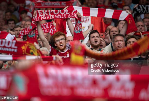 Liverpool fans hold up their scarves whilst singing 'You'll Never Walk Alone' before the Premier League match between Liverpool and Crystal Palace at...