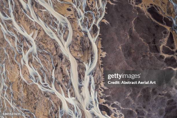 drone shot showing abstract patterns created by a braided river, iceland - delta stock pictures, royalty-free photos & images