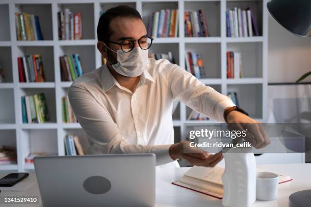 businessman using disinfection wipes during covid-19 - antiseptic wipe stockfoto's en -beelden