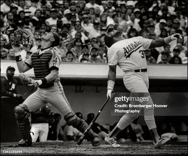 American baseball player Andy Allanson , catcher for the Cleveland Indians, watches a foul ball hit by Dave Parker, of the Oakland Athletics, during...