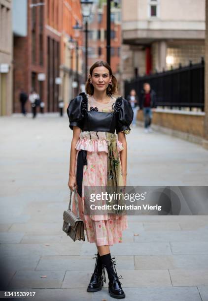 Alexa Chung is seen wearing dress, Gucci bag outside Simone Rocha during London Fashion Week September 2021 on September 20, 2021 in London, England.