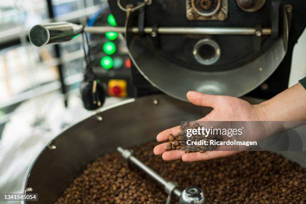 coffee roaster machine grinds coffee - colombian people stock pictures, royalty-free photos & images