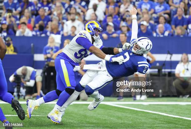 Aaron Donald of the Los Angeles Rams hits Carson Wentz of the Indianapolis Colts at Lucas Oil Stadium on September 19, 2021 in Indianapolis, Indiana.