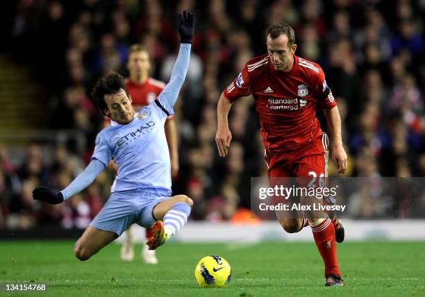 Charlie Adam of Liverpool is challenged by David Silva of Manchester City during the Barclays Premier League match between Liverpool and Manchester...