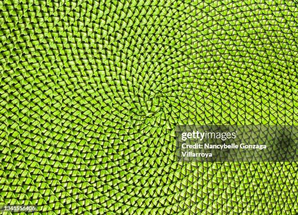 close up of a bright green  centre of a woven straw mat - place mat stock pictures, royalty-free photos & images