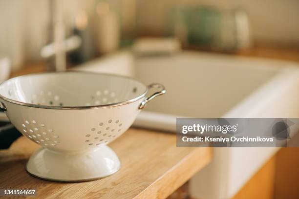 colanders and tray on kitchen table - sieve stock pictures, royalty-free photos & images