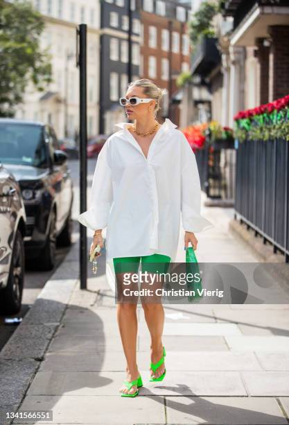 Caroline Ebo is seen wearing white button shirt, green bag, shorts outside Paul & Joe during London Fashion Week September 2021 on September 20, 2021...