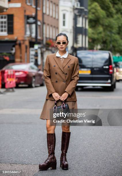 Betty Bachz is seen wearing brown blazer, Ferragamo bag, skirt outside Paul & Joe during London Fashion Week September 2021 on September 20, 2021 in...