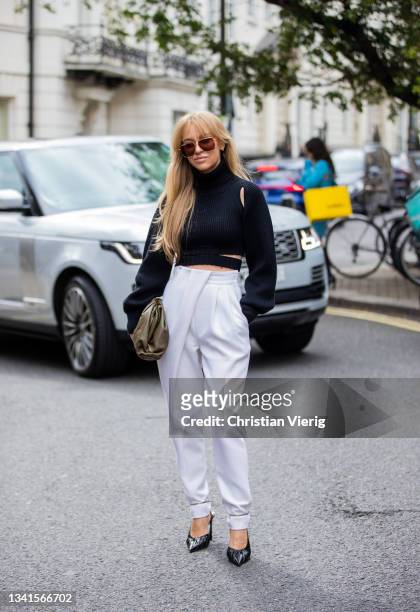 Sandra Hagelstam seen wearing white white pants, black top, green bag outside Paul & Joe during London Fashion Week September 2021 on September 20,...