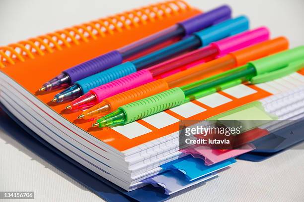 notebook with colored pens - workbook stockfoto's en -beelden