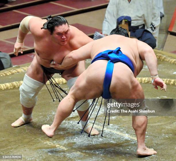 Yokozuna Terunofuji throws Hokutofuji to win during day four of the Grand Sumo Autumn Tournament at Ryogoku Kokugikan on September 15, 2021 in Tokyo,...