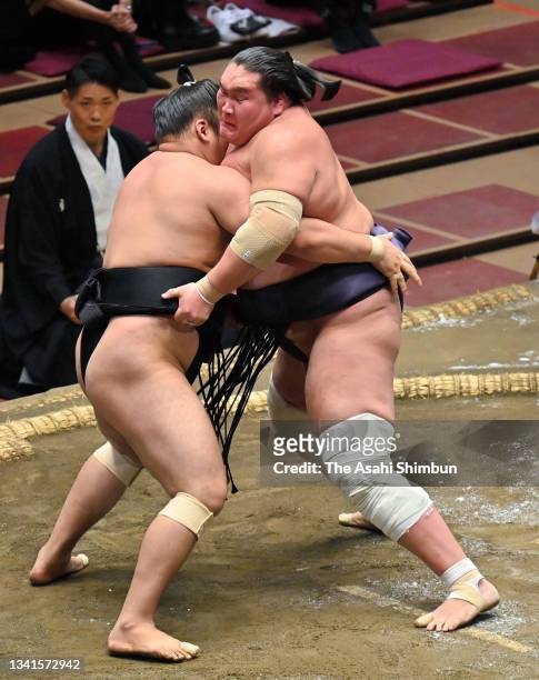 Yokozuna Terunofuji pushes Kiribayama out of the ring to win during day five of the Grand Sumo Autumn Tournament at Ryogoku Kokugikan on September...