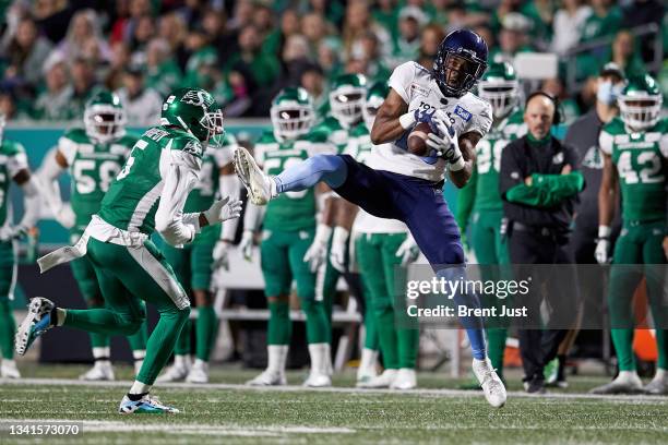 Dejon Brissett of the Toronto Argonauts makes a catch in front of Loucheiz Purifoy of the Saskatchewan Roughriders in the game between the Toronto...