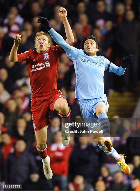 Lucas Leiva of Liverpool goes up with David Silva of Manchester City during a Barclays Premier League match between Liverpool and Manchester City at...