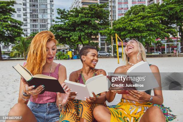 friends relaxing at the beach with book and beer - beach book reading stock pictures, royalty-free photos & images