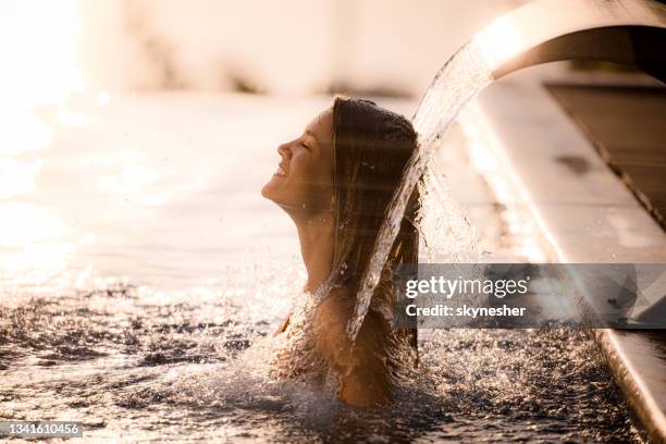 happy woman having hydrotherapy in the pool. - balneotherapy stock pictures, royalty-free photos & images