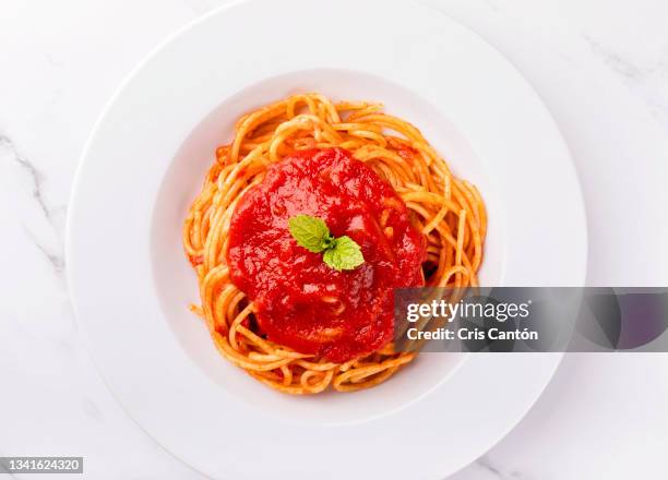 spaghetti with tomato sauce on white background. - tomato sauce stock pictures, royalty-free photos & images