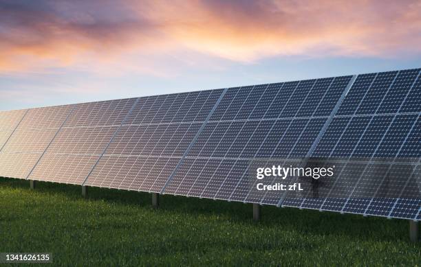 solar panel on field against sky - solar panel foto e immagini stock