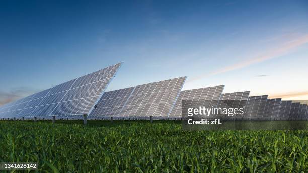solar panel on field against sky - solar fotografías e imágenes de stock