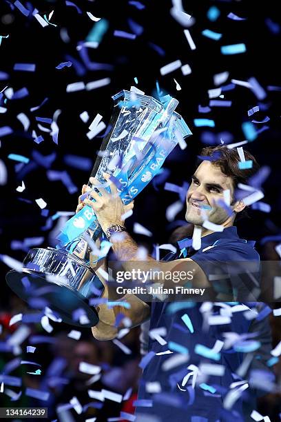 Roger Federer of Switzerland lifts the trophy following his victory during the men's final singles match against Jo-Wilfried Tsonga of France during...