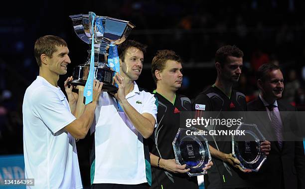 Daniel Nestor of Canada and partner Max Mirnyi of Belarus pose with the ATP World Tour Finals tennis tournament doubles champions' trophy next to...