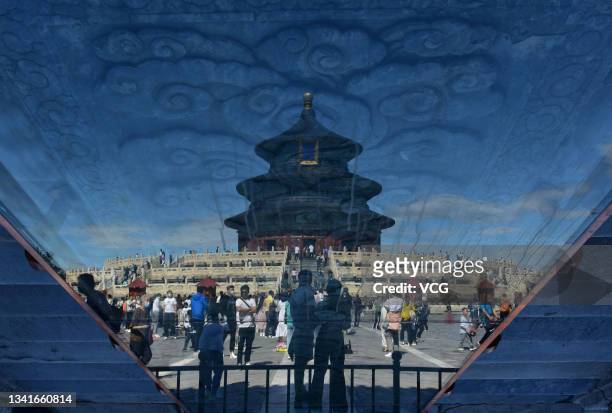 Tourists visit the Temple of Heaven Park during Mid-Autumn Festival Holiday on September 21, 2021 in Beijing, China.