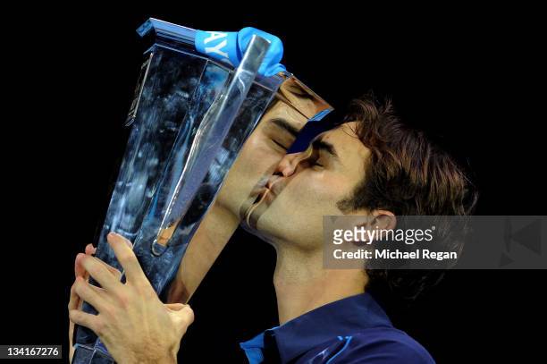 Roger Federer of Switzerland kisses the trophy following his victory during the men's final singles match against Jo-Wilfried Tsonga of France during...