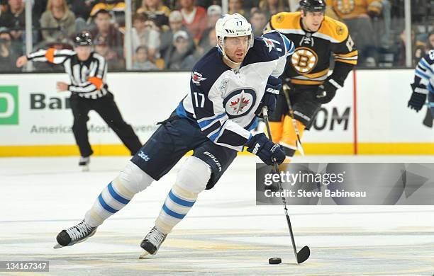 Eric Fehr of the Winnipeg Jets skates with the puck against the Boston Bruins at the TD Garden on November 26, 2011 in Boston, Massachusetts.