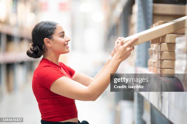 young woman is shopping for home at furnishings store. - self service stock pictures, royalty-free photos & images