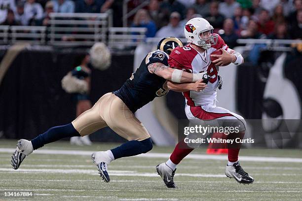 Quarterback John Skelton of the Arizona Cardinals is brought down by defensive end Chris Long of the St. Louis Rams in the second half of the game on...