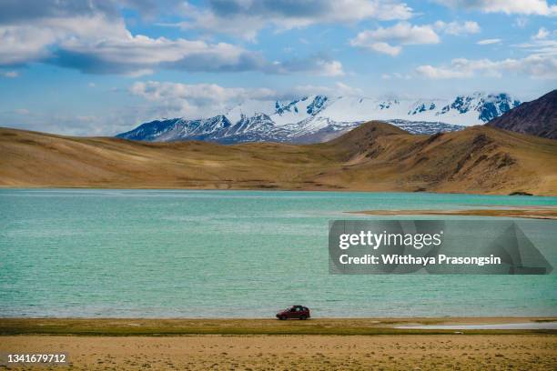 gravel road at sunset with vestrahorn mountain and a car driving ladakh - jammu and kashmir bildbanksfoton och bilder