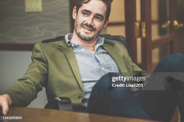 cocksure businessman in an office confident and cool attitude - flamboyant man stock pictures, royalty-free photos & images