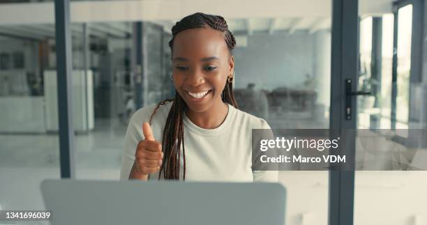 shot of a beautiful young woman on a video call using her laptop in a modern office - good news stock pictures, royalty-free photos & images