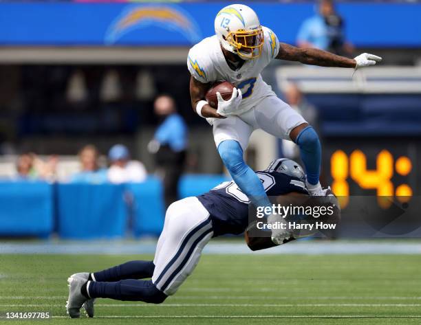 Keenan Allen of the Los Angeles Chargers jumps over the tackle of Anthony Brown of the Dallas Cowboys after his catch during a 20-17 loss to the...