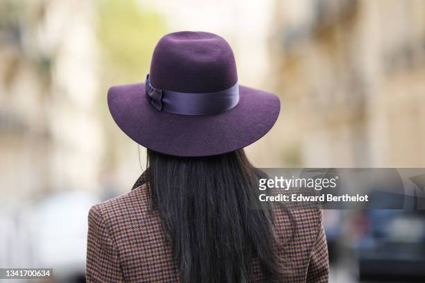 Emilie Joseph @in_fashionwetrust wears silver earring, a burgundy felt fedora Virginie hat from Maison Michel, a brown prince of Wales checked wool...
