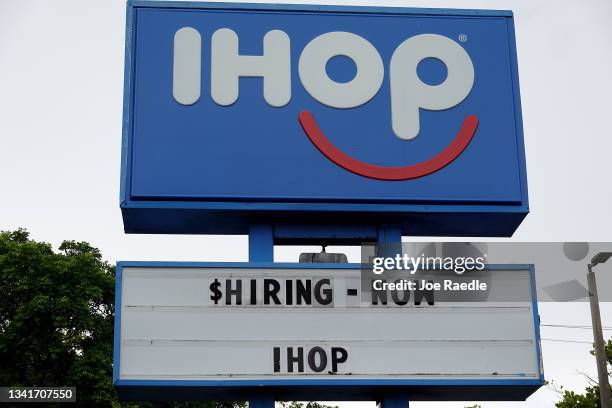 Hiring Now sign near the entrance to an IHOP restaurant on September 21, 2021 in Hallandale, Florida. Government reports indicate that Initial...