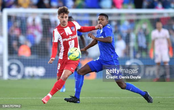 Antoine Griezmann of Atletico Madrid battles for possession with Florentino Luis of Getafe during the La Liga Santander match between Getafe CF and...