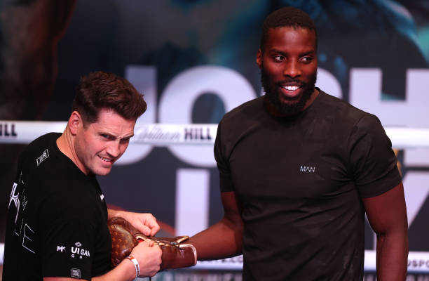 Lawrence Okolie speaks to his trainer Shane McGuigan during their media work out ahead of the WBO World Cruiserweight Title fight between Lawrence...