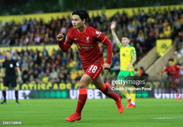 Takumi Minamino of Liverpool celebrates after scoring their sides first goal during the Carabao Cup Third Round match between Norwich City and...