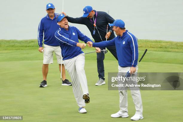 Ian Poulter of England and team Europe and Paul Casey of England and team Europe react on the 17th green prior to the 43rd Ryder Cup at Whistling...