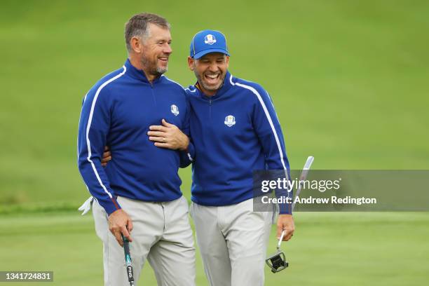 Lee Westwood of England and team Europe and Sergio Garcia of Spain and team Europe react on the 18th green prior to the 43rd Ryder Cup at Whistling...