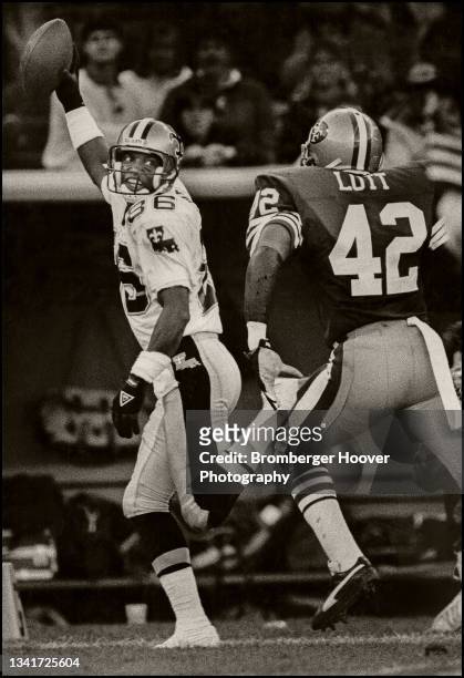 American football player Mike Jones , of the New Orleans Saints, celebrates a touchdown as Ronnie Lott, of the San Francisco 49ers, chases him during...