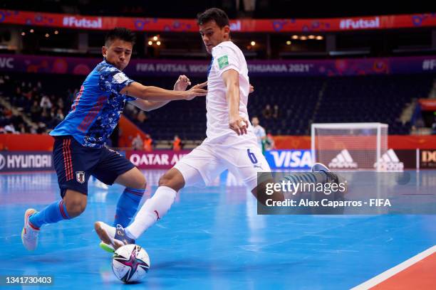 Richard Rejala of Paraguay is challenged by Katsutoshi Henmi of Japan during the FIFA Futsal World Cup 2021 group E match between Japan and Paraguay...