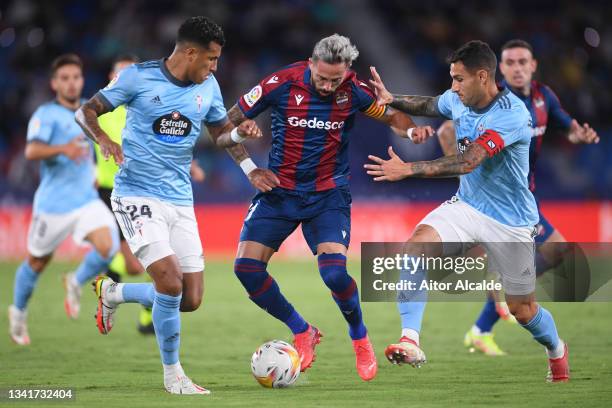 Jose Luis Morales of Levante battles for possession with Jeison Murillo and Hugo Mallo of Celta Vigo during the La Liga Santander match between...