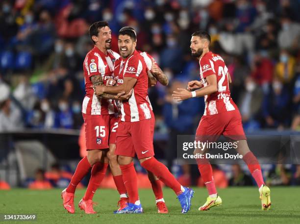 Luis Suarez of Atletico de Madrid celebrates with teammate Stefan Savic of Atletico de Madrid after scoring their team's 1st goal during the La Liga...