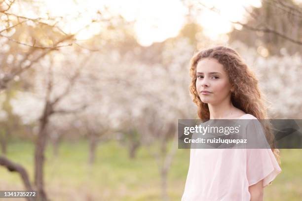 teenage beautiful girl surrounded by cherry trees in spring - argentina girls stock pictures, royalty-free photos & images